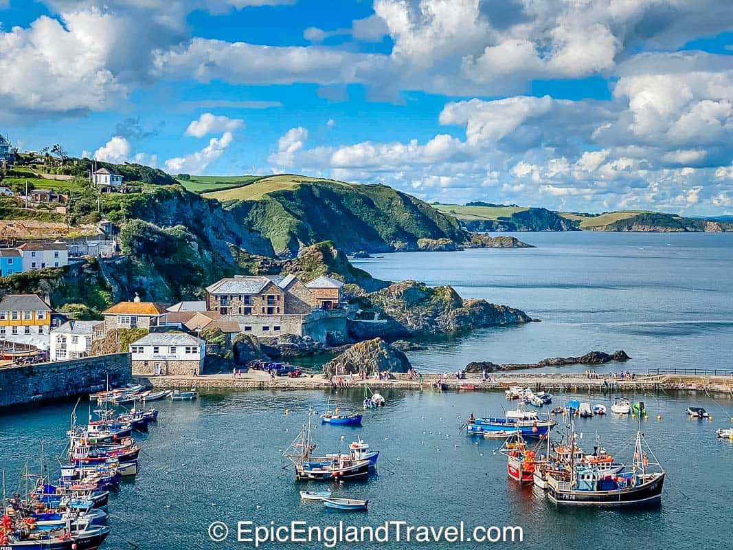 cornwall coastline with fishing boats and village